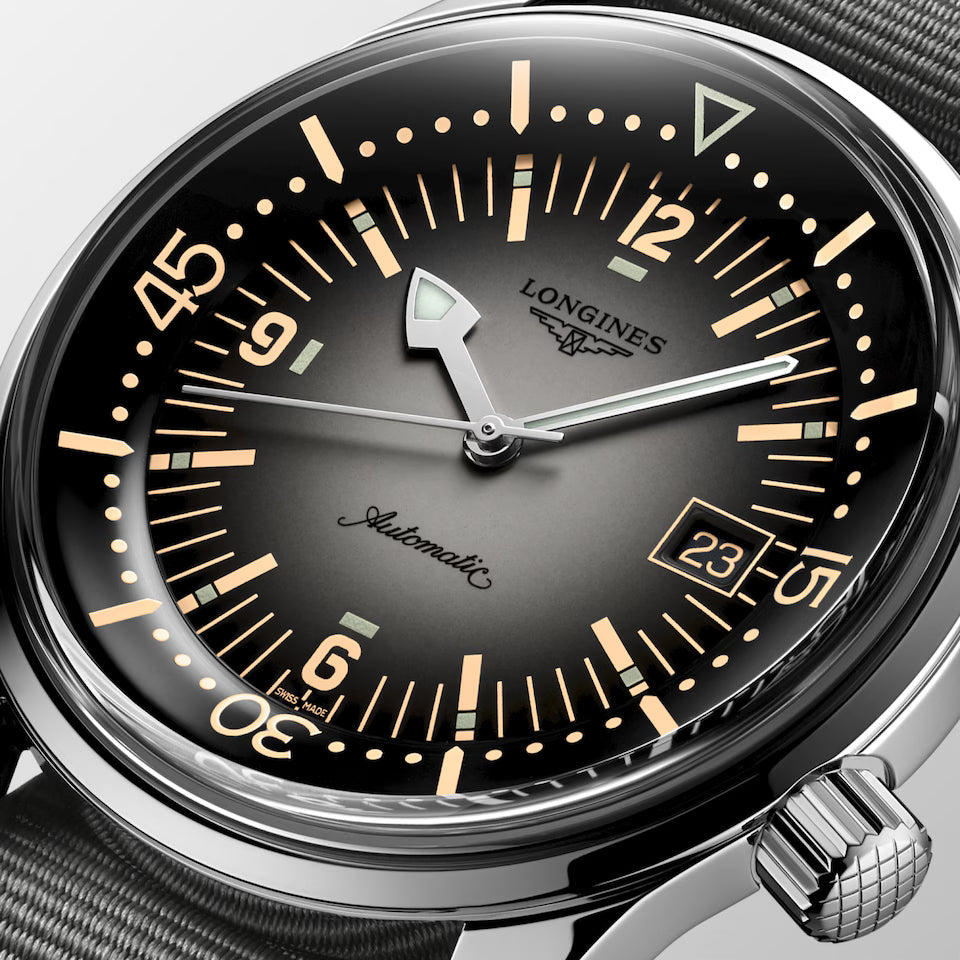 Longines watch with black dial and silver case on a light gray background