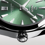 Close-up of a green Omega watch face with silver accents on a white background