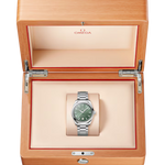 Omega watch in a wooden box on a white background