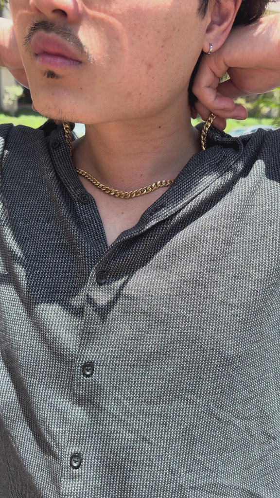 video of male showcasing gold chain on model's neck