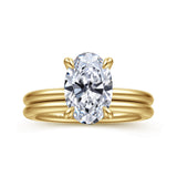 A yellow gold ring with a large oval-cut clear gemstone in a four-prong setting, shown on a plain white background.