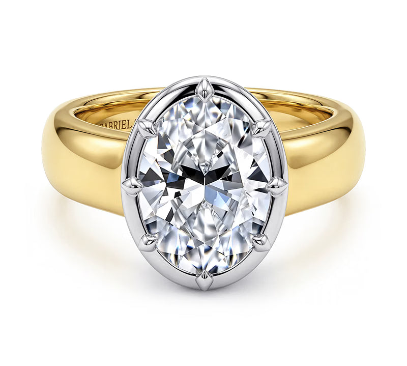 Gabriel & Co. oval solitaire engagement ring with white gold prongs on a wide 14K yellow gold band, front view