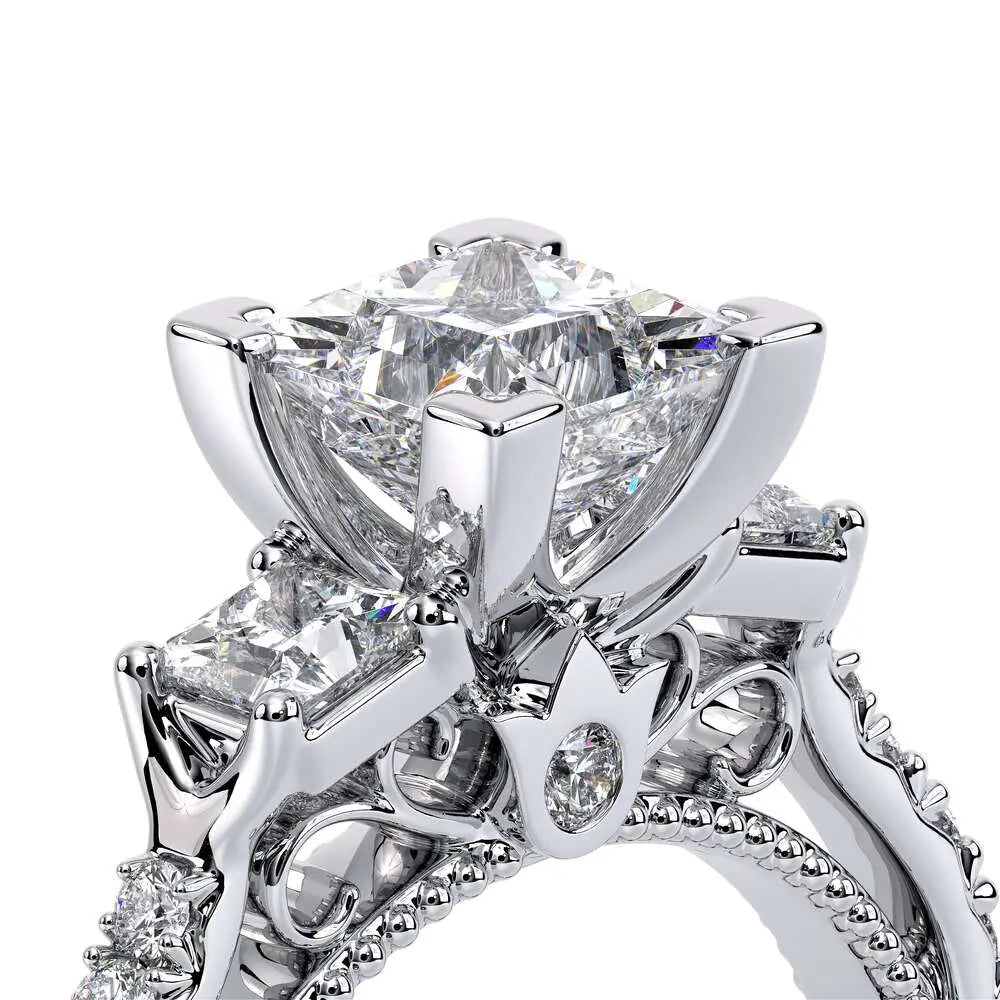 Close-up of a diamond ring with intricate design on a white background