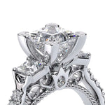 Close-up of a diamond ring with intricate design on a white background