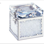 A Swarovski crystal cube keepsake box with a faceted clear crystal lid, silver-toned metal frame, and textured clear crystal inlay on the front, shown on a white background.