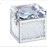 A Swarovski crystal cube keepsake box with a faceted clear crystal lid, silver-toned metal frame, and textured clear crystal inlay on the front, shown on a white background.