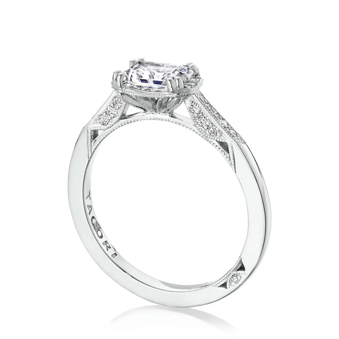 Diamond ring with 'Tacori' engraving on a white background
