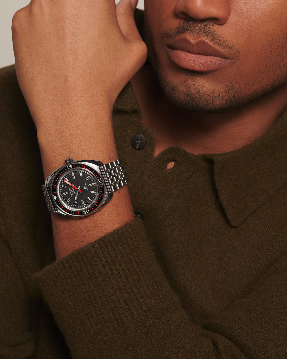 Man wearing a watch with a brown sweater
