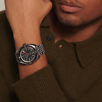 Man wearing a watch with a brown sweater