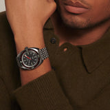 Man wearing a watch with a brown sweater
