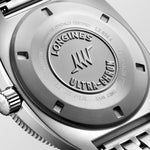 Close-up of a Longines watch caseback with branding and certification details.