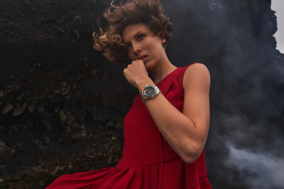 Woman in a red dress with a dark, textured background
